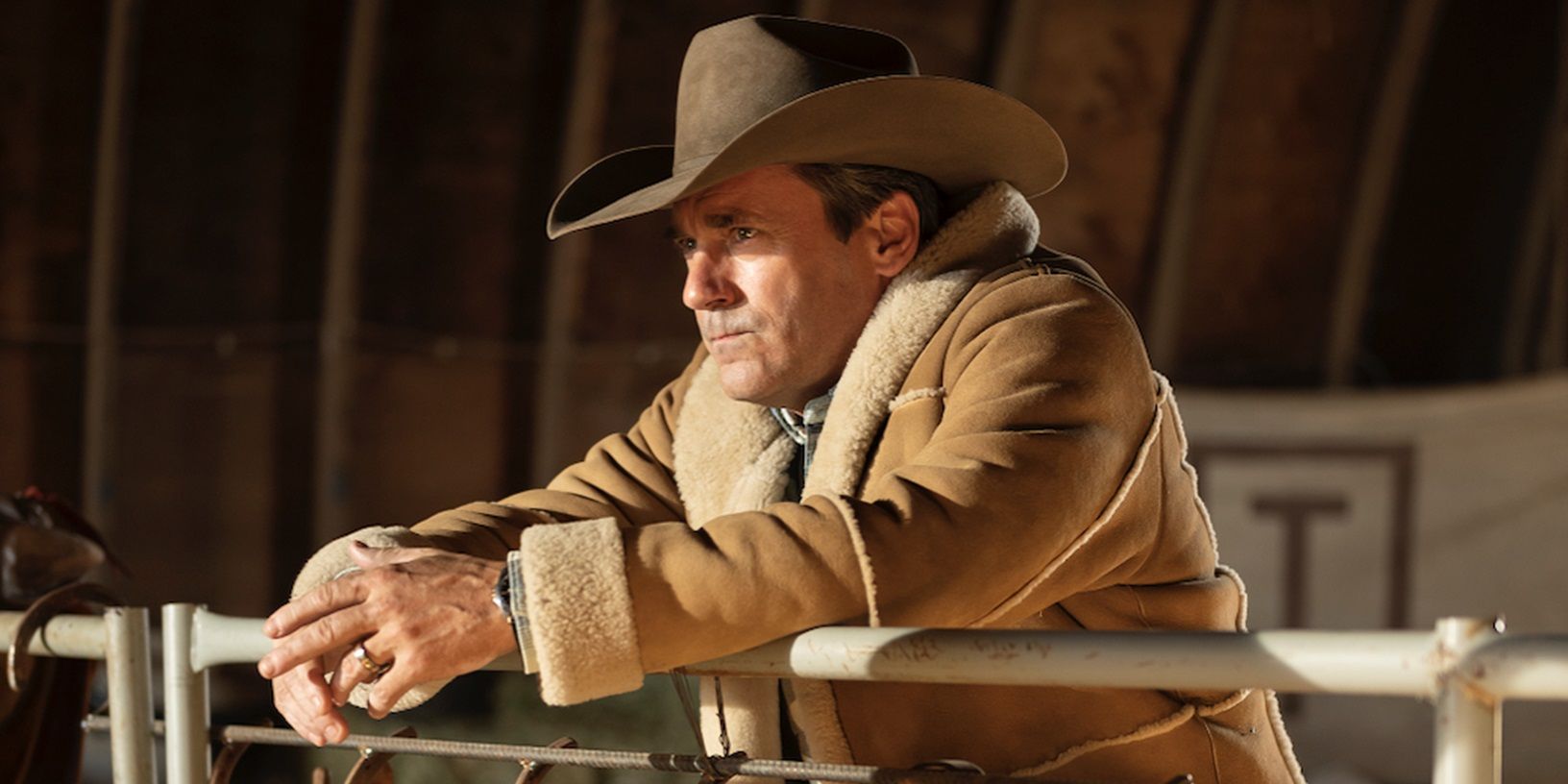 Jon Hamm leaning on a fence in Fargo